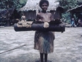 Girl carrying a large drum