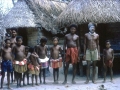 Colourful group on Munawata island - note the typical Trobriand Island houses