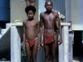 Two boys passing through Losuia Government Station